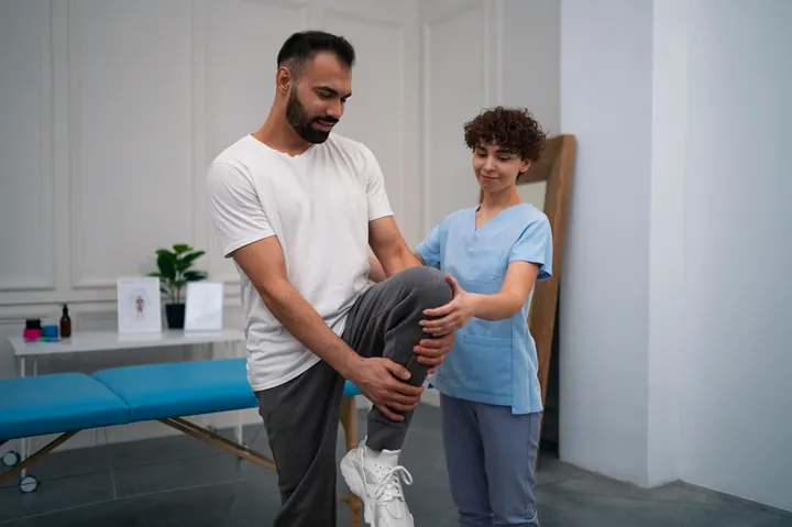 A patient doing guided knee exercises during rehabilitation